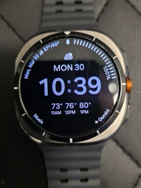 Samsung Gray Smartwatch with Orange Accent and Dark Gray Band